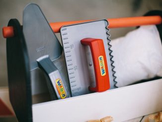 Vibrant plastic toy toolkit featuring trowel and square. Perfect for imaginative play.
