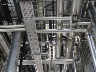 Vertical shot of steel pipes and ventilation in an industrial setting.