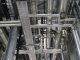 Vertical shot of steel pipes and ventilation in an industrial setting.