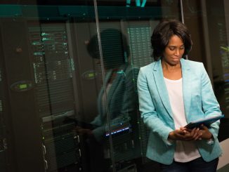 Female IT professional examining data servers in a modern data center setting.