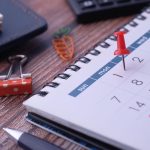 Desk elements like calendar and pins for effective planning.