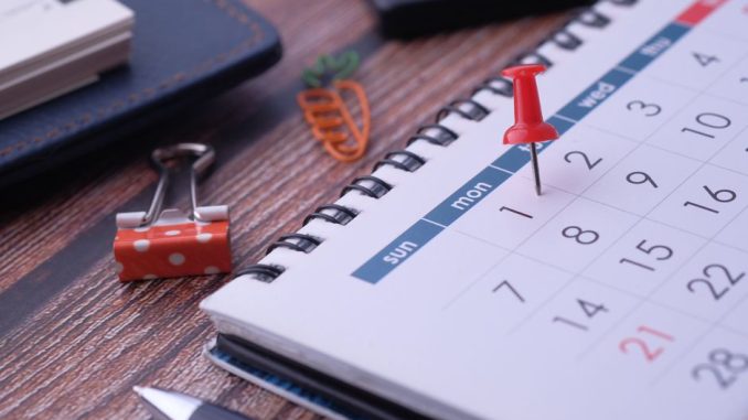 Desk elements like calendar and pins for effective planning.